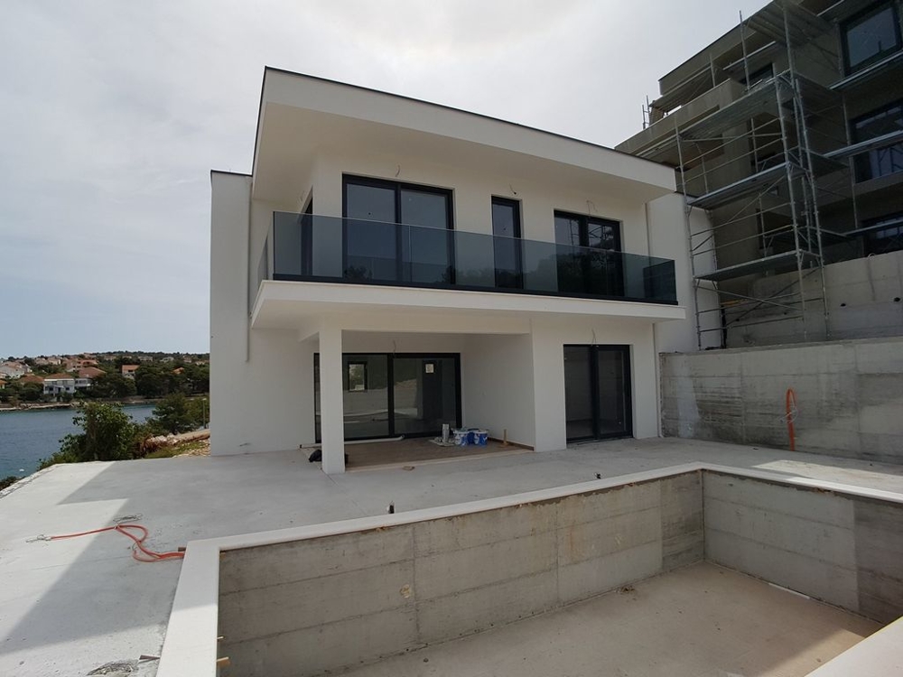Sicht vom Swimmingpool auf den Liegebereich, Terrasse und das Haus direkt am Meer - Haus kaufen Kroatien.